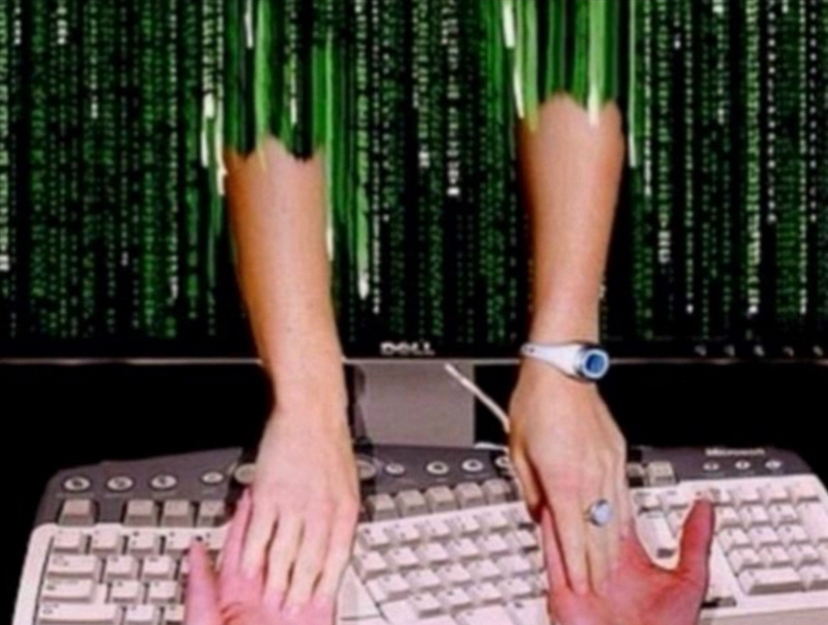 Arms reach through a computer screen to touch the hands on the keyboard.